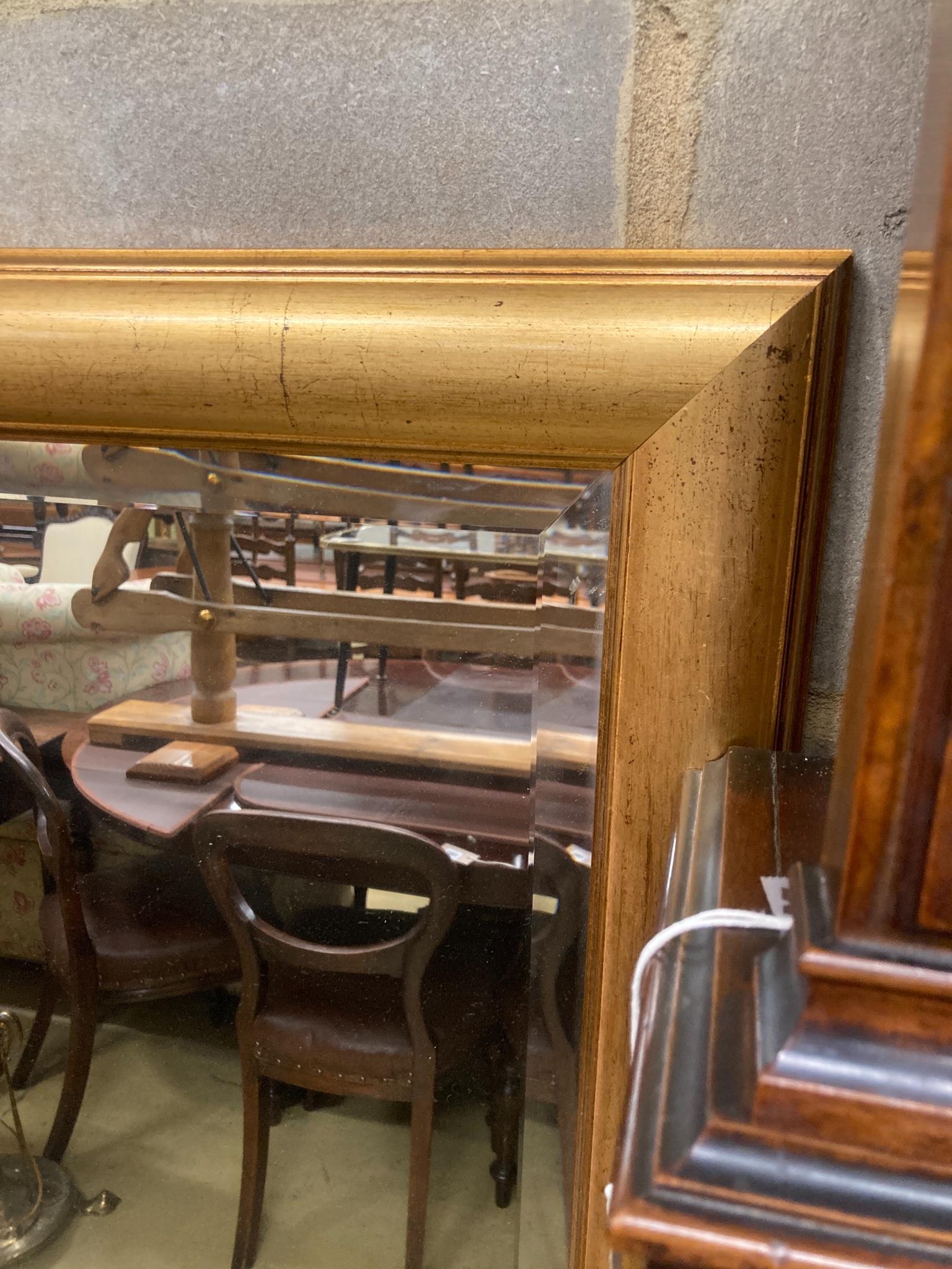 A contemporary rectangular gilt framed wall mirror, W.150cm H.96cm